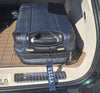 Blue suitcase with a U.S. Coast Guard Academy (USCGA) tag inside an open car trunk.